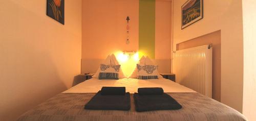 a bedroom with a bed with two pillows on it at Aqua Ház Panzió 2 in Balatonfüred
