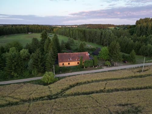 an aerial view of a house in the middle of a field at Stary Dom, a może in Kruklanki