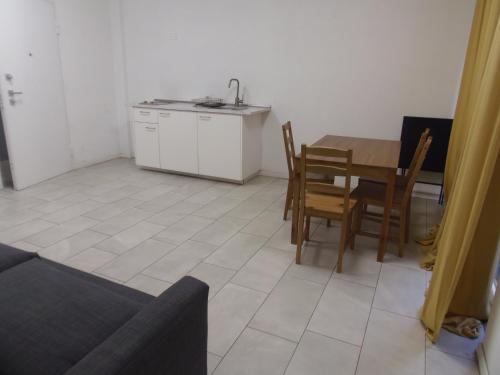 a kitchen and dining room with a table and chairs at Apartaments and Rooms Claudia Augusta in Bolzano