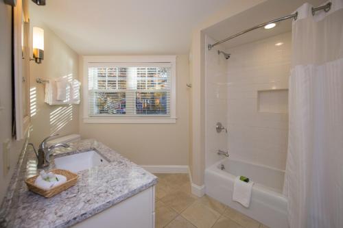 y baño con lavabo, bañera y ducha. en Juniper Hill Inn, en Ogunquit