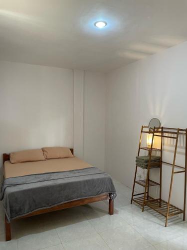 a bedroom with a bed and a ladder in it at Buhay Probinsya - Bubolongan in El Nido