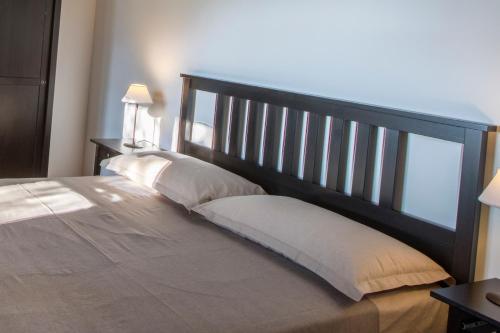 a bedroom with a large bed with two pillows at Poggio di mare in Castelluzzo