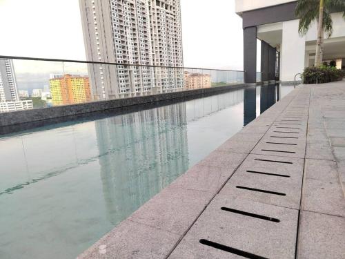 a pool of water in the middle of a building at Seaview Infinity Pool , 40th , 9pax, 3Rooms 2Carpark in Jelutong