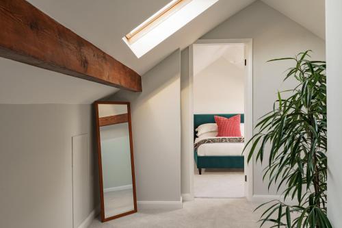 a skylight in a room with a bed and a mirror at Yewbeck: brand new, garden views in Windermere