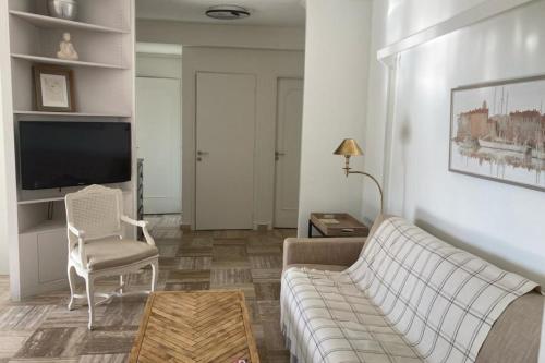 een woonkamer met een bank en een tv bij WE CANNES ! Sea View & Large Terrace LA VISTA in Cannes