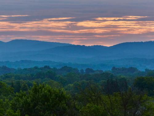 a view of a valley with mountains in the distance at Graduate by Hilton Charlottesville in Charlottesville