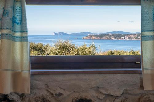 a view of the ocean from a window at PedrAmare Suite in Alghero