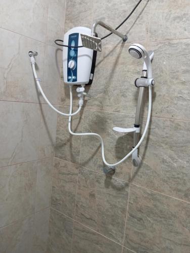 a hair dryer is attached to a wall in a bathroom at ROCK VIEW inn in Padukka