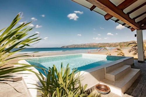 a swimming pool with a view of the beach at CASA ROSA 49’ - Playa Venao Beach in Playa Venao
