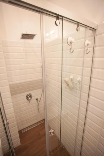 a shower stall with a glass door with at Presidency House Self Check-in Apartments in Sofia