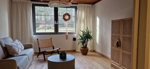 a living room with a couch and a table at Lustro Wody in Osiek