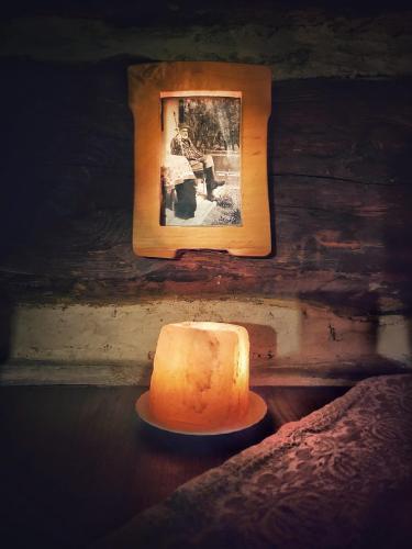 a cake sitting on a table next to a picture at Fecskefészek Vendégház Őriszentpéter in Őriszentpéter
