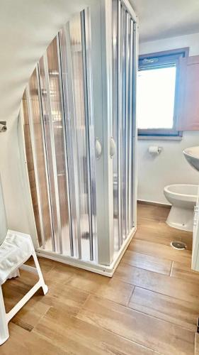 a bathroom with a shower and a toilet and a sink at HomeClass Mercantile in Bari