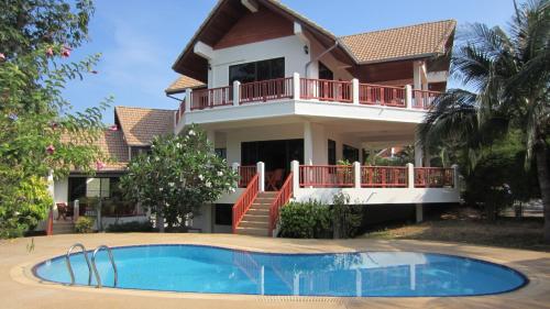 a house with a swimming pool in front of it at Viewpoint Residence 2 Bedroom Villa in Koh Samui 