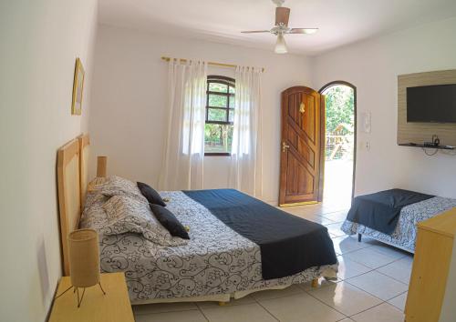 Ένα ή περισσότερα κρεβάτια σε δωμάτιο στο HOTEL POUSADA PARAÍSO