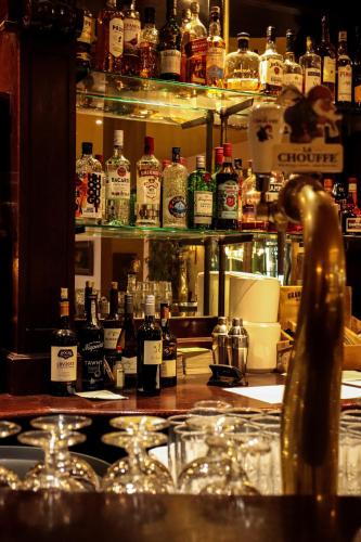 a bar with a lot of bottles of alcohol at Hotel Schimmelpenninck Huys in Groningen