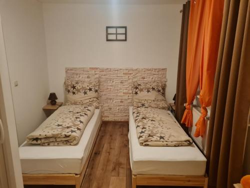 two beds in a room with a brick wall at Alex Meißner in Großalmerode