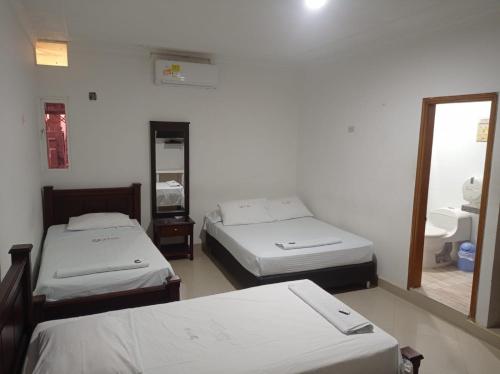 Postel nebo postele na pokoji v ubytování Hotel Damys