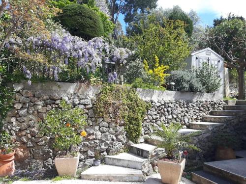 una pared de piedra con un montón de plantas y flores en Haut de villa Toulon Mourillon, en Toulon