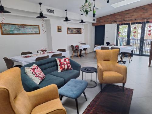 a living room with a couch and chairs and tables at Stara Plebania in Ponice