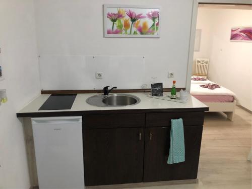 a bathroom with a sink and a bed in a room at Ferienwohnung Just City in Wismar