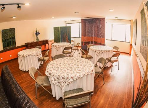 a room with tables and chairs in a room at Hotel Boyaca Plaza in Tunja