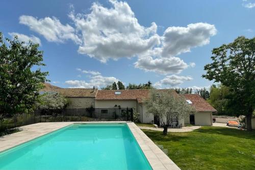 une piscine devant une maison dans l'établissement Maison pleine de charme, à Dammartin-en-Serve