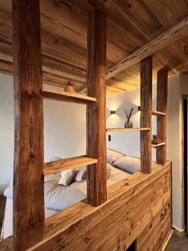 two beds in a room with wooden beams at Le Nid de l'Aiguille - Au pied de l'Aiguille du midi in Chamonix-Mont-Blanc