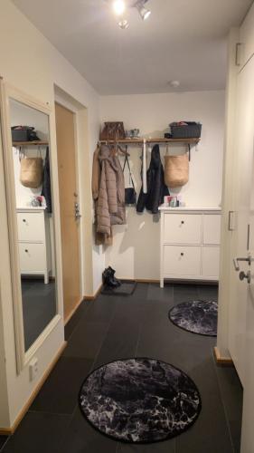 a room with a closet with two rugs on the floor at Eurovision 2024 in Malmö