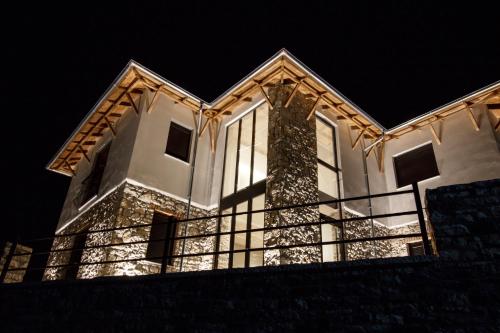 a house lit up at night with lights at Bujtina KOEL in Gjirokastër