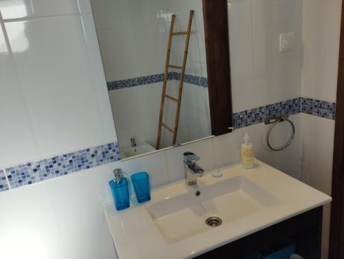 a bathroom with a sink and a mirror at Casa Sarguito in Sagres