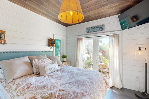 a bedroom with a bed and a large window at Luxurious Haven in Tavernier