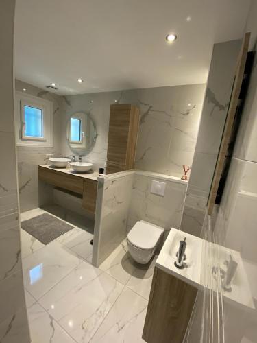une salle de bain blanche avec des toilettes et un lavabo dans l'établissement Haut de villa Toulon Mourillon, à Toulon