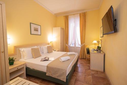 a hotel room with a bed and a television at Hotel Belvedere San Gottardo by LVG Hotel Collection in Verbania