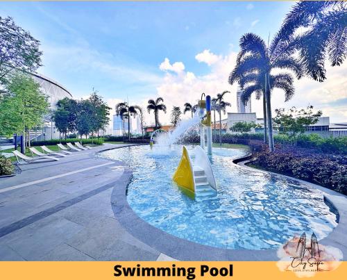 a water park with a swimming pool with a fountain at Trion @ Kuala Lumpur near KLCC TRX by Cityscape in Kuala Lumpur