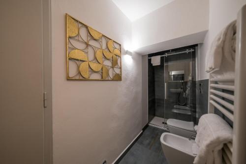 a bathroom with a sink and a glass shower at Lungarno Buozzi 7 Apartments in Pisa