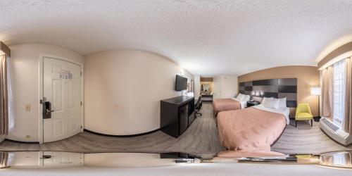 a hotel room with a bed and a bedroom at Quality Inn Johnson City I-26 exit 17 in Johnson City