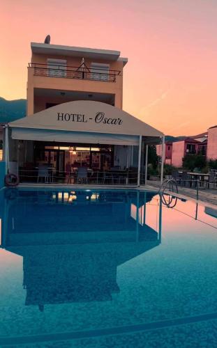 a hotel with a swimming pool in front of a building at Oscar Hotel Lefkada in Nydri