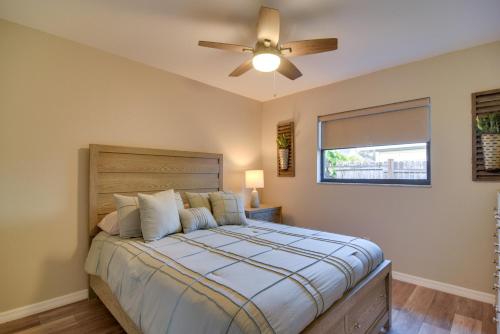 a bedroom with a bed with a ceiling fan at Ideally Located Palm Harbor Condo Walk Downtown! in Palm Harbor