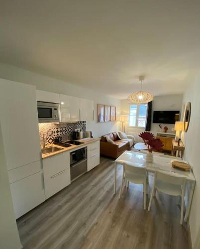 Il comprend une cuisine et un salon avec une table. dans l'établissement Appart centre ville Orleans, à Orléans