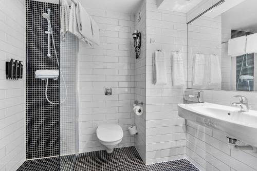 a bathroom with a toilet and a sink and a shower at Best Western Plus Park Globetrotter Copenhagen Airport in Copenhagen