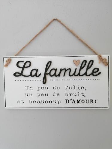 a sign that says la famille on a wall at La Maison des Rosiers in Manhac