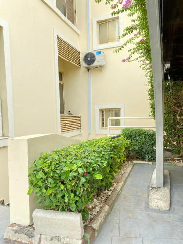 a building with a hedge in front of a building at Glovis Luxury Suites in Abuja