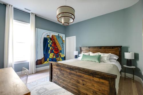 a bedroom with a wooden bed with a painting on the wall at Vetro Guest House in Richmond