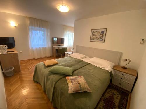 a bedroom with a large bed and a desk at Rooms Base in Split