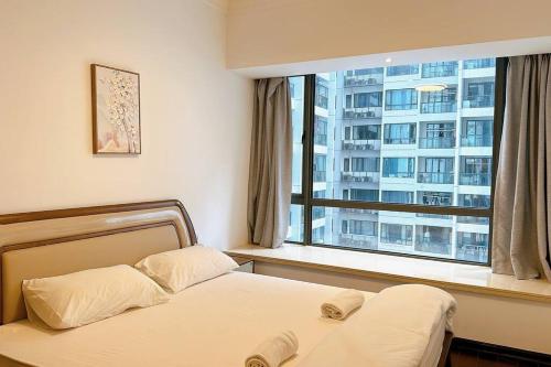 a bedroom with a bed and a large window at F13 R&F 2BR Swimming Pool @ CIQ in Johor Bahru