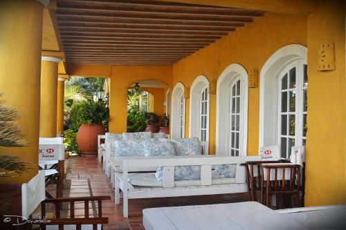 a porch with couches and chairs on a patio at Hotel La Bluette in Punta del Este