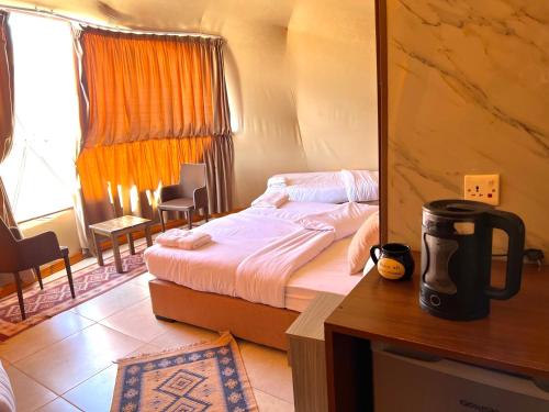 a small bedroom with a bed and a mirror at STAR of Wadi Rum in Wadi Rum