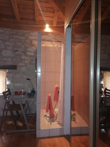 a glass door leading into a room with a table at Chez Yvette & Shoji in Mauvezin