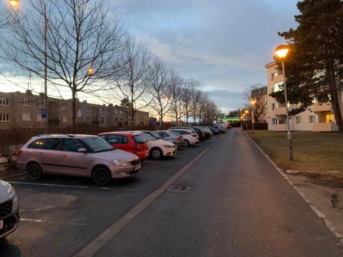 a row of cars parked in a parking lot at Přízemí v parku. (Apartment no.8) in Znojmo
